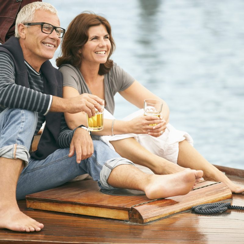 Middle aged couple drinking on boat
